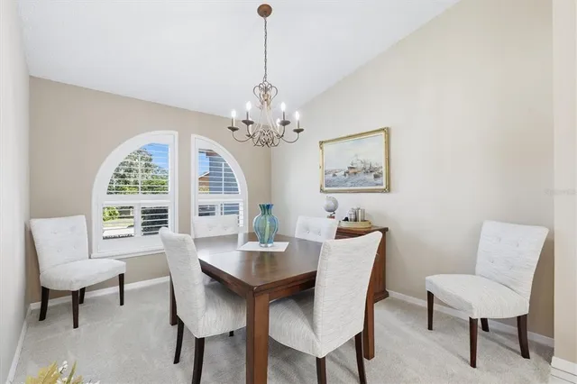 a view of a dining room with a table and chairs