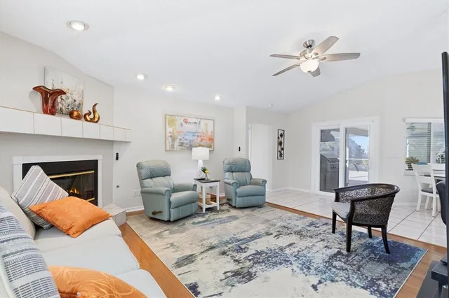a living room with furniture a fireplace and kitchen view