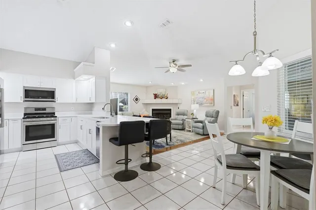 a view of a dining room with furniture and chandelier
