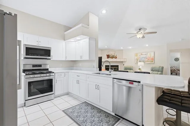 a kitchen with a sink stove and refrigerator