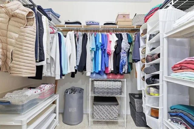 a spacious bathroom with a double vanity sink a mirror and a bathtub