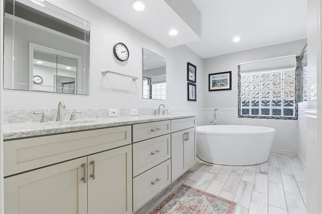 a bathroom with a bathtub and a shower