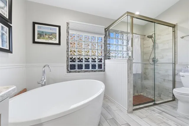 a white bath tub sitting next to a window