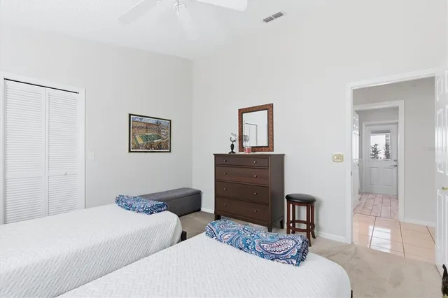 a bathroom with a granite countertop sink mirror and a toilet