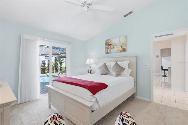 a bedroom with a bed and a lamp on dresser