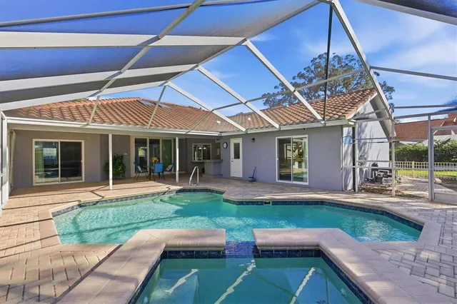 a view of a house with a big yard and a garden