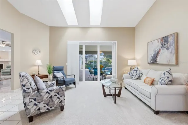 a living room with furniture and a chandelier