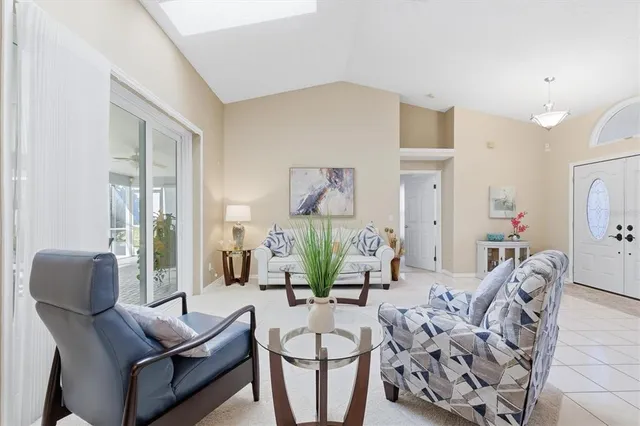 a living room with furniture a dining table and a chandelier