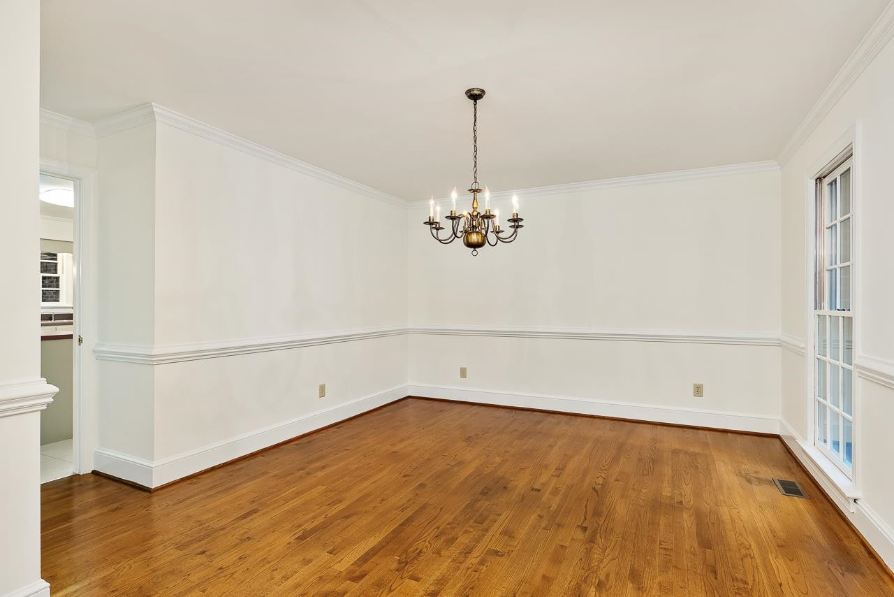 8724 Fort Macon Court Raleigh, NC 27615 - Photo 12 of 30 Rich hardwoods and chair rail add sophisticated detail, and the large windows bring in lots of natural light. Formal dining