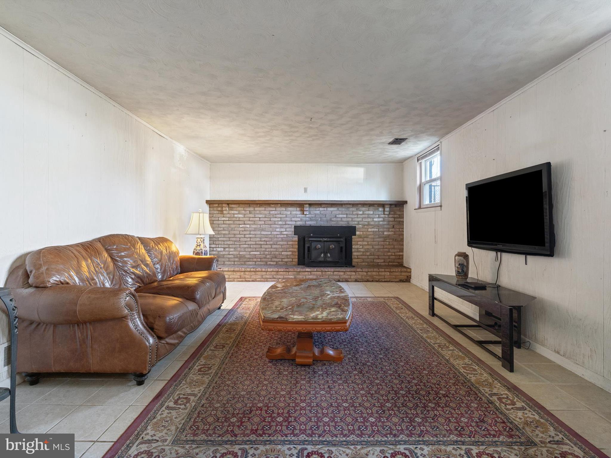 1345 Ava Road Severn, MD 21144 - Photo 29 of 41 a living room with furniture and a flat screen tv