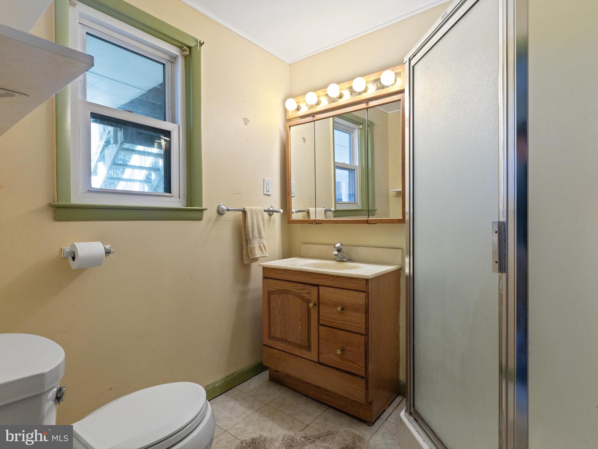 1345 Ava Road Severn, MD 21144 - Photo 34 of 41 a bathroom with a granite countertop toilet a sink and mirror