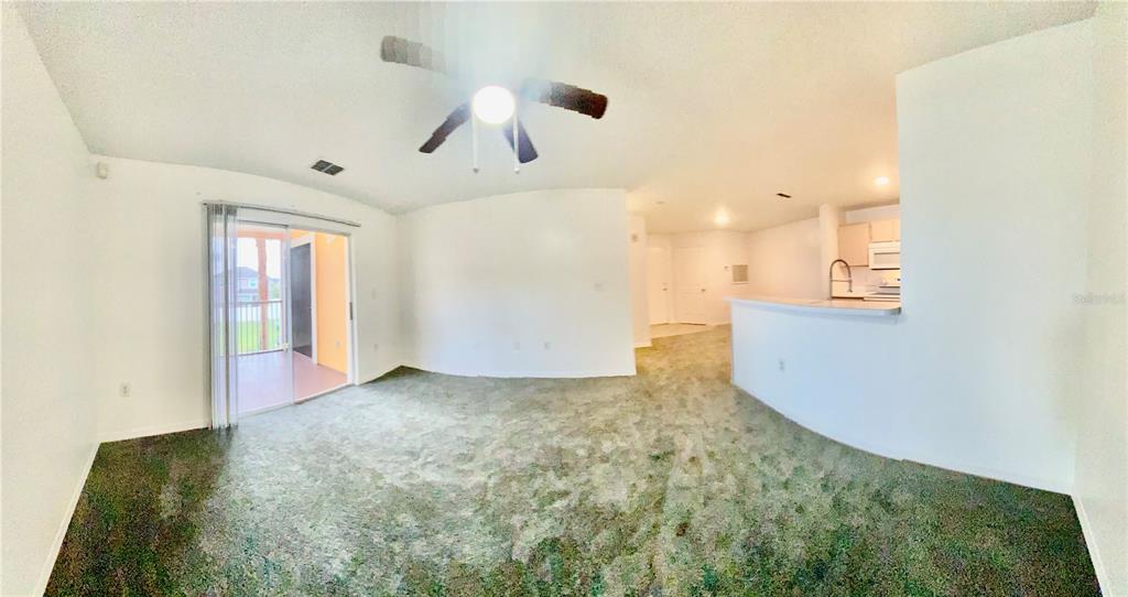 5459 Vineland Road, Unit 4210 Orlando, FL 32811 - Photo 13 of 25 a view of an empty room with window and kitchen view