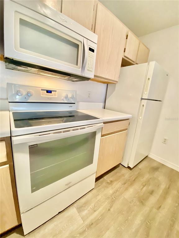 5459 Vineland Road, Unit 4210 Orlando, FL 32811 - Photo 19 of 25 a stove top oven sitting inside of a kitchen