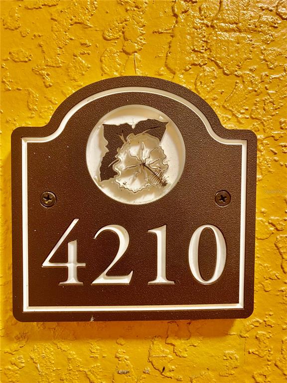 5459 Vineland Road, Unit 4210 Orlando, FL 32811 - Photo 2 of 25 a blue sign that is on the side of a wall
