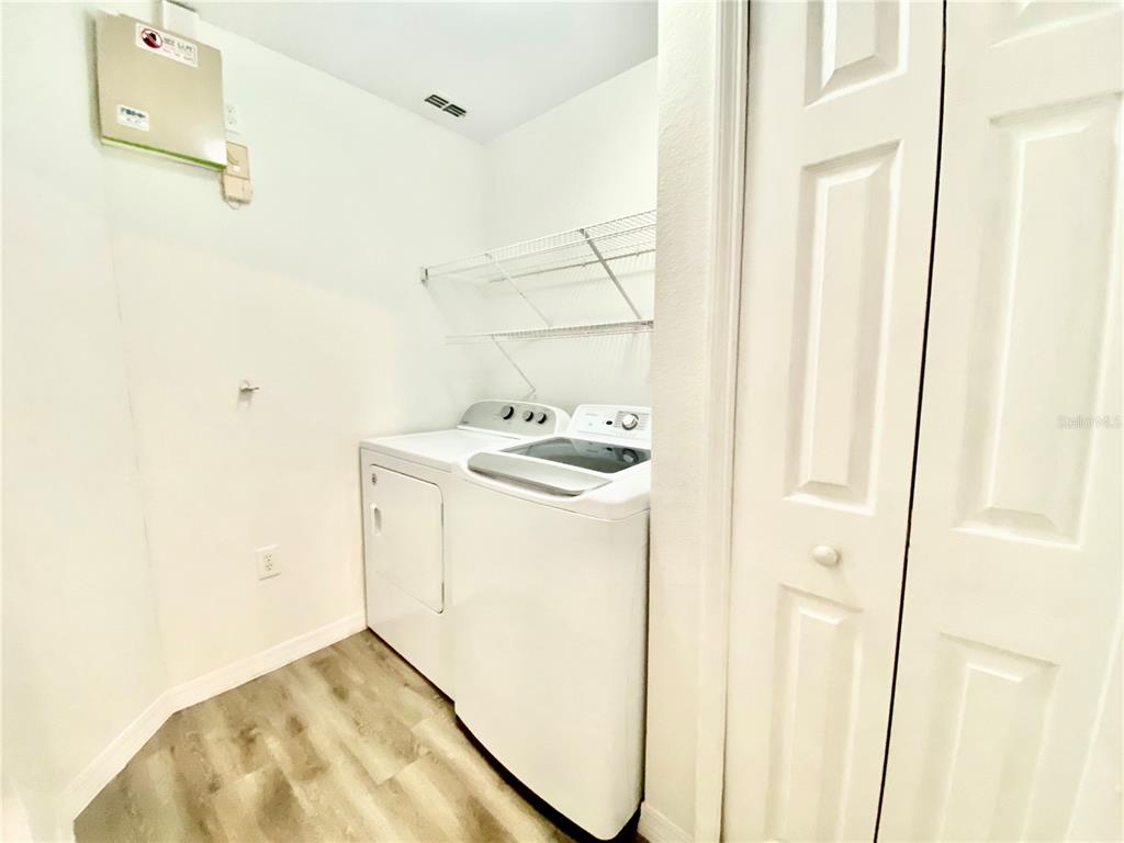 5459 Vineland Road, Unit 4210 Orlando, FL 32811 - Photo 5 of 25 a utility room with dryer and washer
