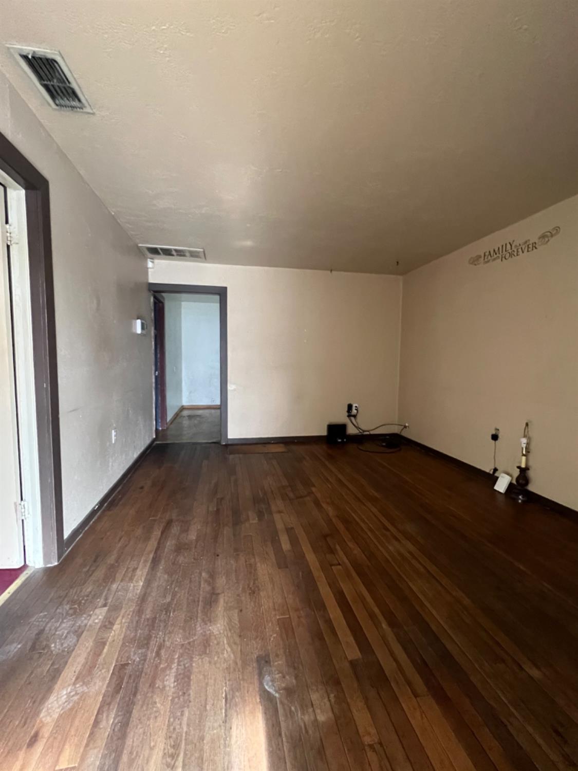 47 West Olive Avenue Madera, CA 93637 - Photo 2 of 10 a view of empty room with wooden floor