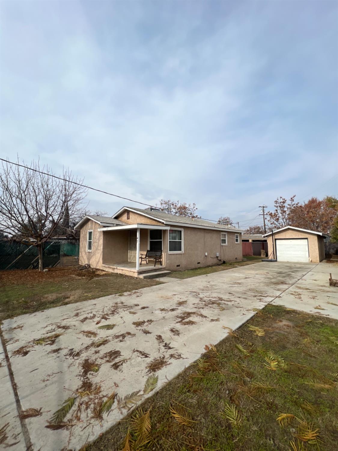 47 West Olive Avenue Madera, CA 93637 - Photo 9 of 10 a big house with a big yard and large tree