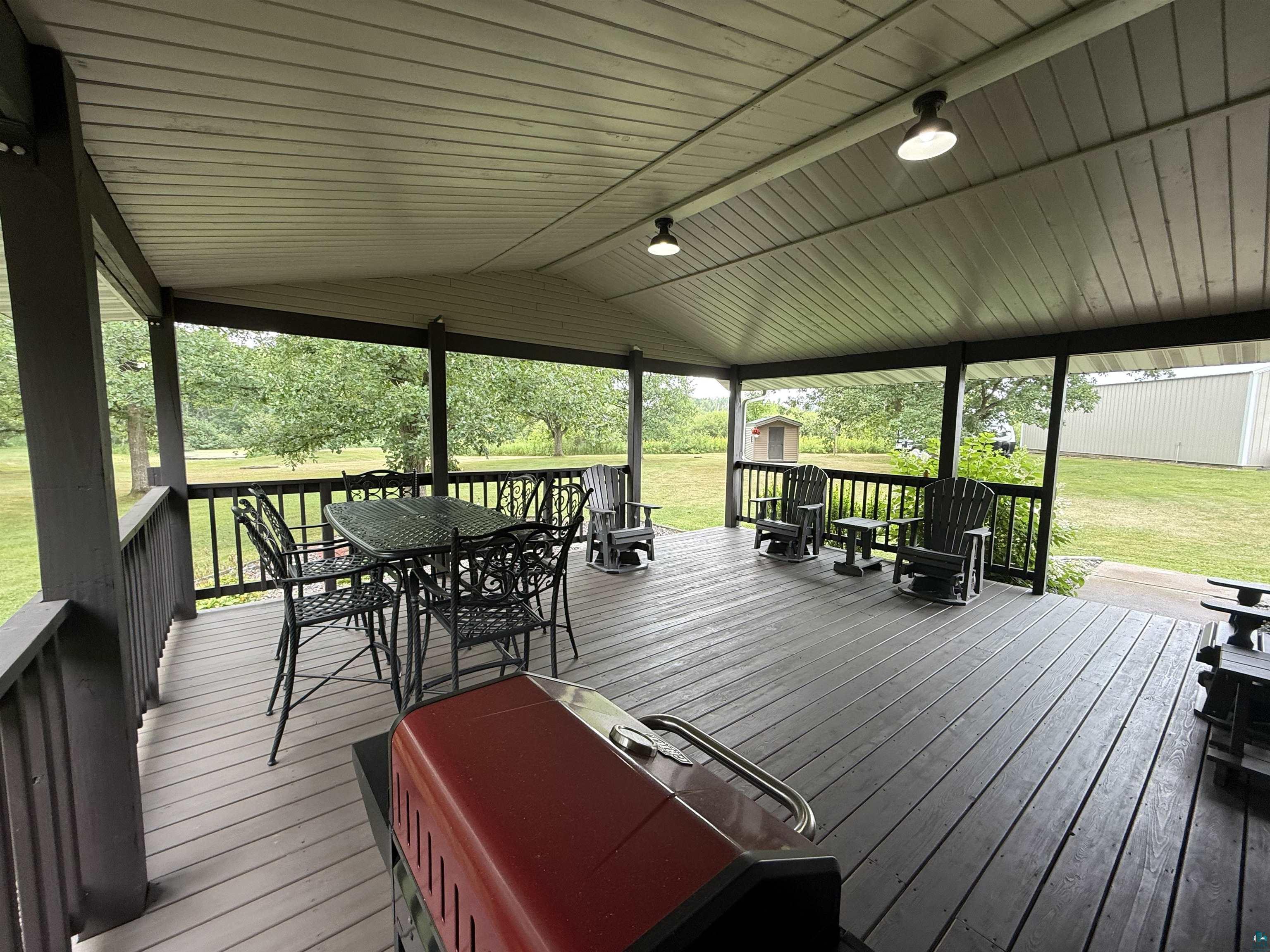 5080 Tower Road Moose Lake, MN 55767 - Photo 17 of 49 Spacious covered porch with wood-finish decking and integrated lighting