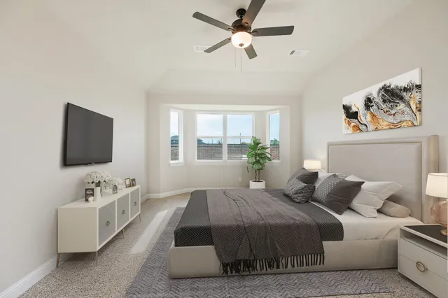 a bedroom with a large bed and a flat screen tv