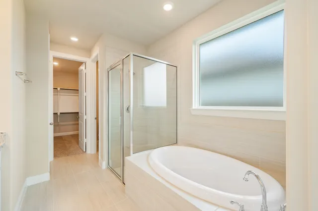 a bathroom with a bathtub and a shower
