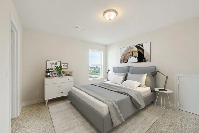 a bedroom with a bed and dresser