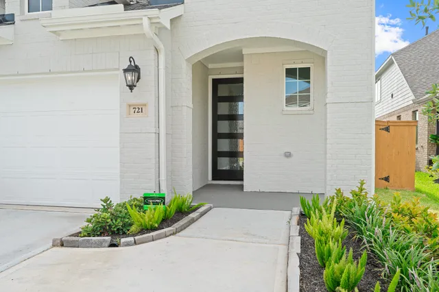a front view of a house with a garden