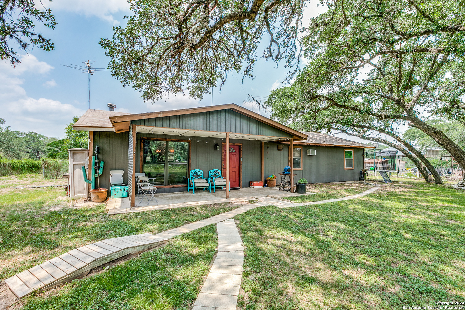 a front view of a house with a yard table and chairs