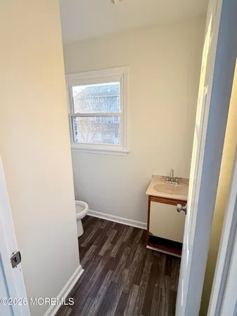 a room with a wooden floor and a window