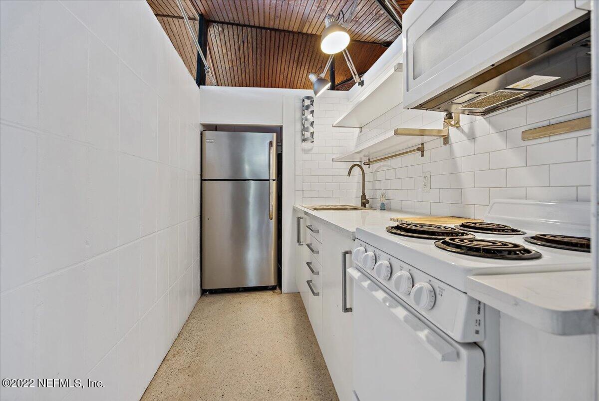 1613 Ocean Boulevard Atlantic Beach, FL 32233 - Photo 8 of 9 a kitchen with a stove and a refrigerator