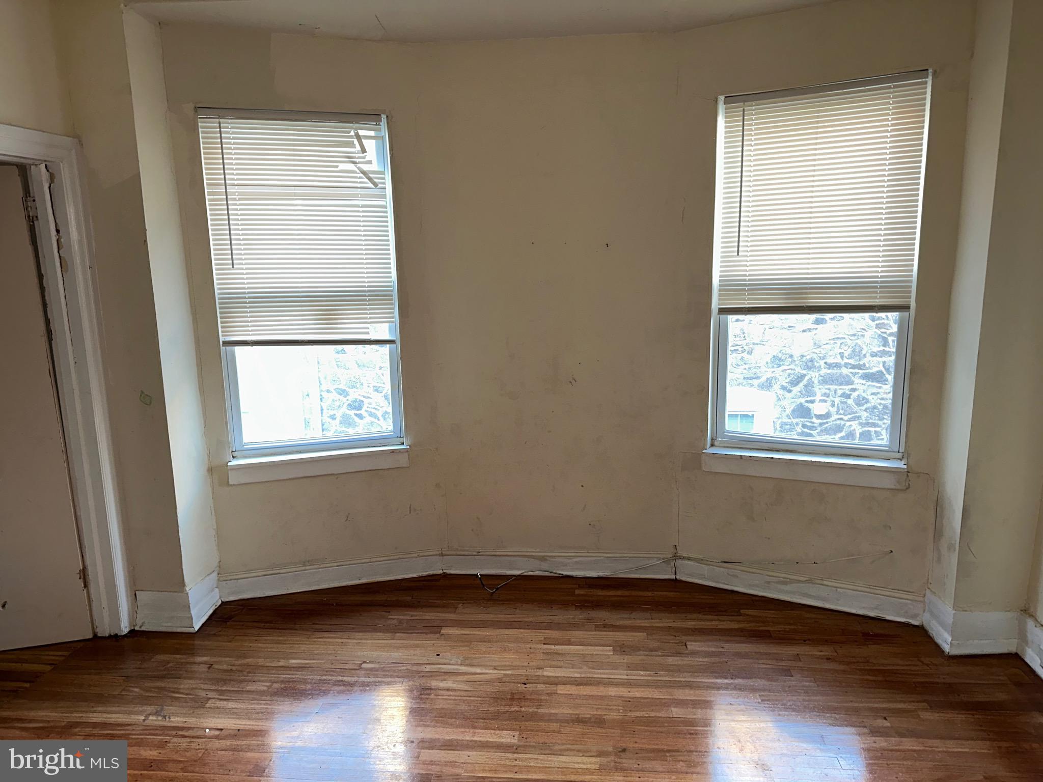 51 High Street Philadelphia, PA 19144 - Photo 12 of 20 a view of an empty room with wooden floor and a window