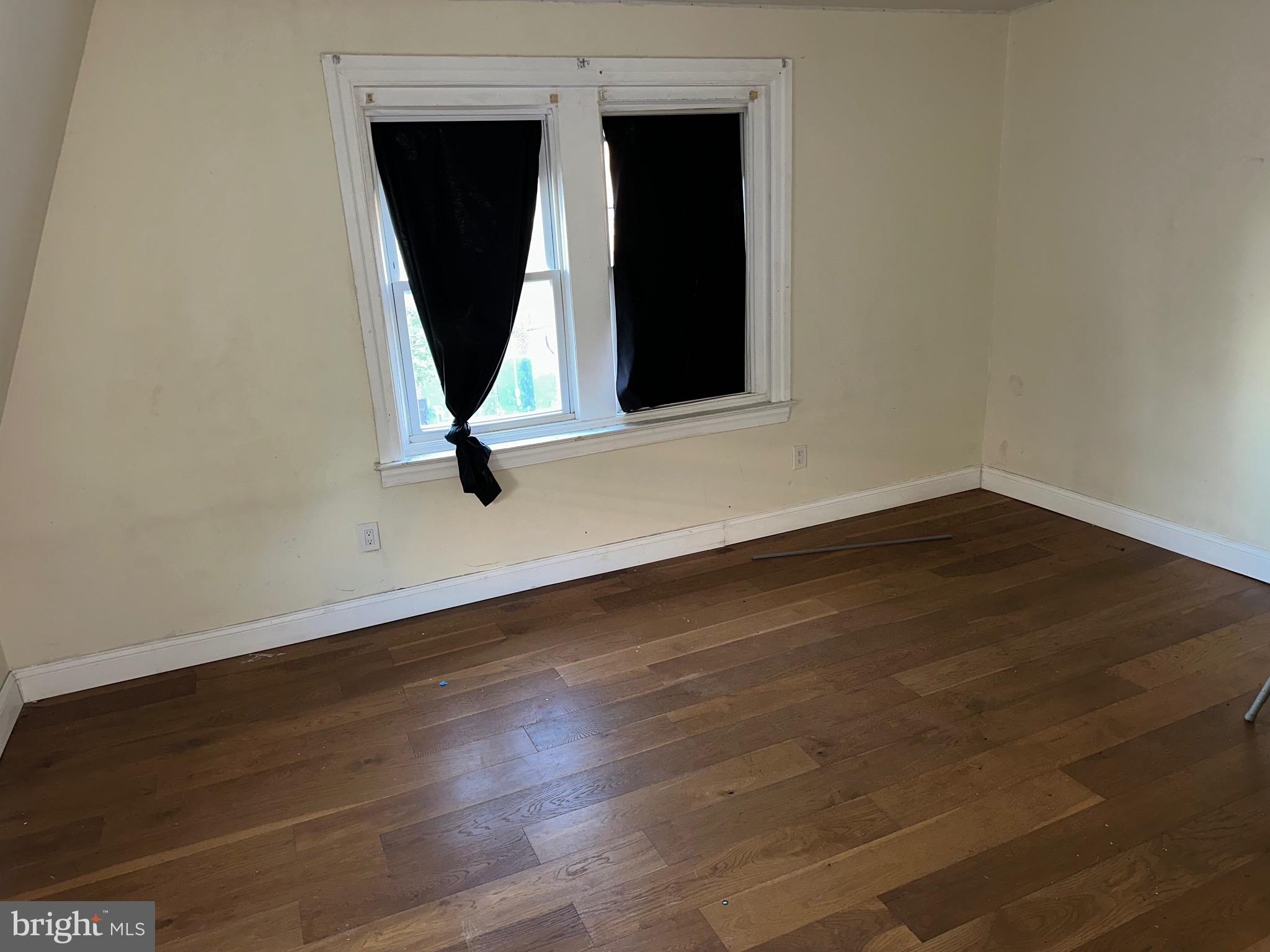 51 High Street Philadelphia, PA 19144 - Photo 16 of 20 an empty room with wooden floor and windows