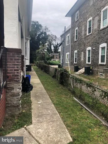 a view of a brick house with many windows