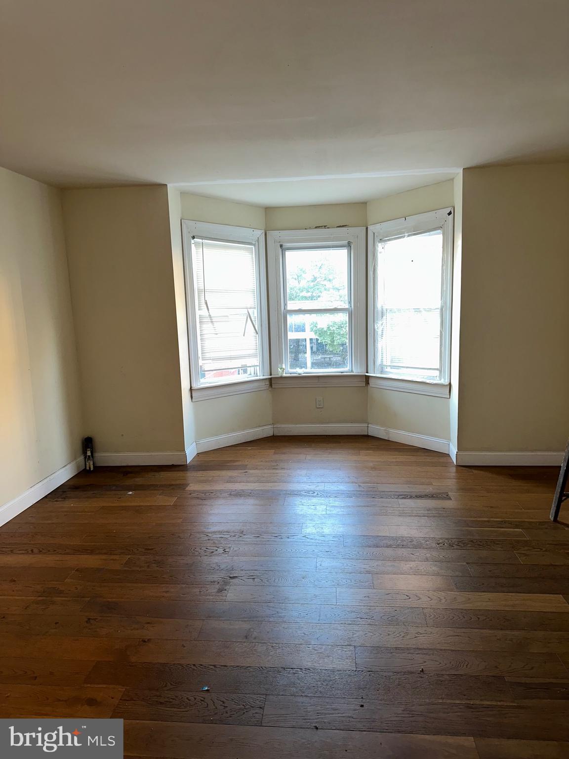 51 High Street Philadelphia, PA 19144 - Photo 10 of 20 an empty room with wooden floor and windows