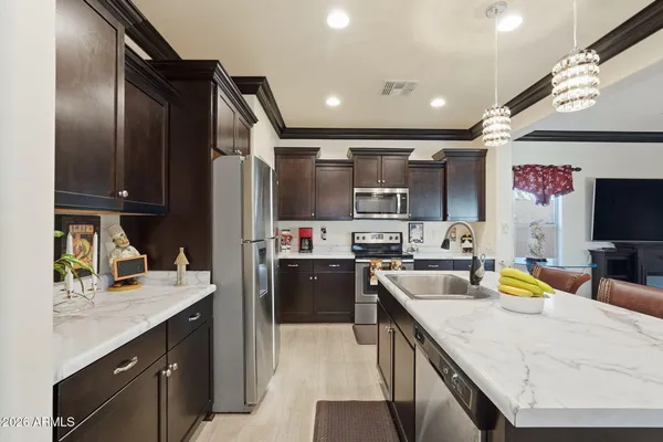 a kitchen with a sink appliances and cabinets