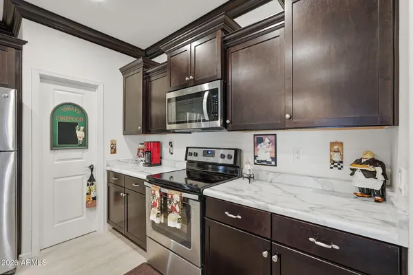 a kitchen with stainless steel appliances granite countertop a sink a stove and cabinets