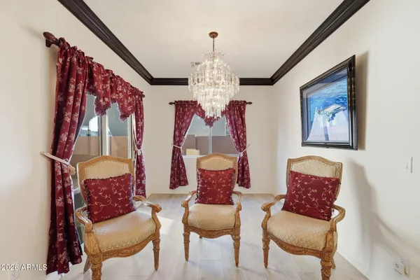 a view of a dining room with furniture and a chandelier