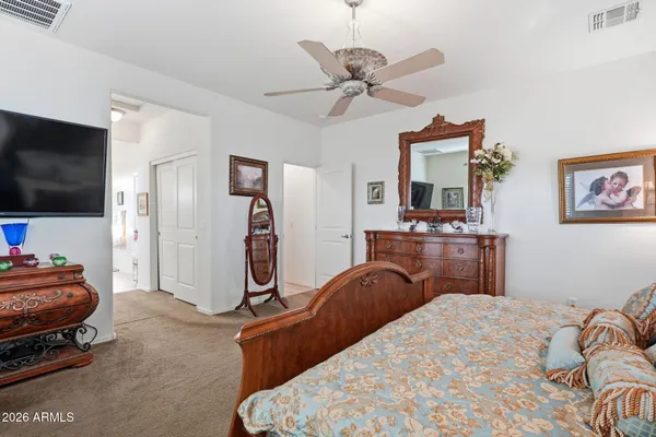 a bedroom with furniture and a flat screen tv
