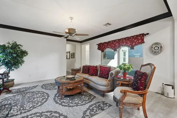 a living room with furniture and wooden floor