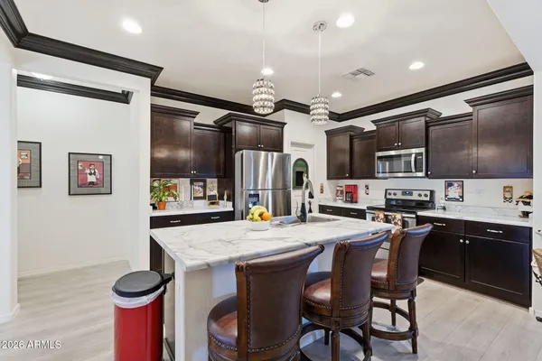 a kitchen with granite countertop cabinets a table and chairs