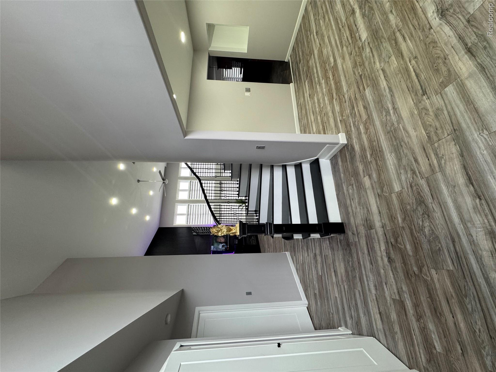 50493 Nesting Ridge Drive Macomb, MI 48044 - Photo 31 of 34 Staircase featuring recessed lighting, wood finished floors, and a towering ceiling