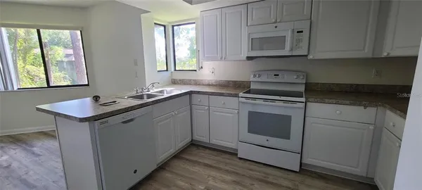 a kitchen with a sink stove and cabinets