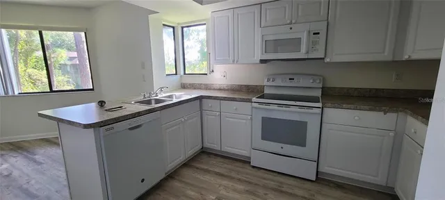 a kitchen with a sink stove and cabinets