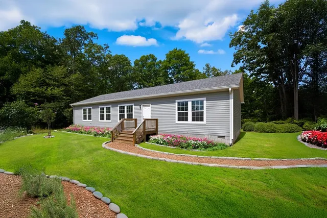 a front view of house with yard and green space