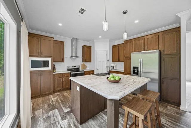a kitchen with refrigerator cabinets and wooden floor