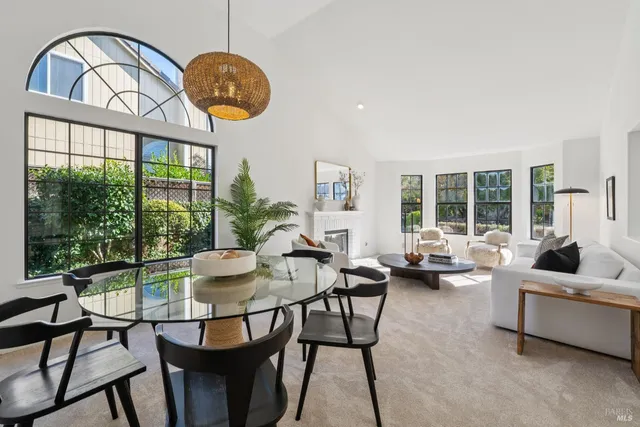 a living room with furniture a large window and a table
