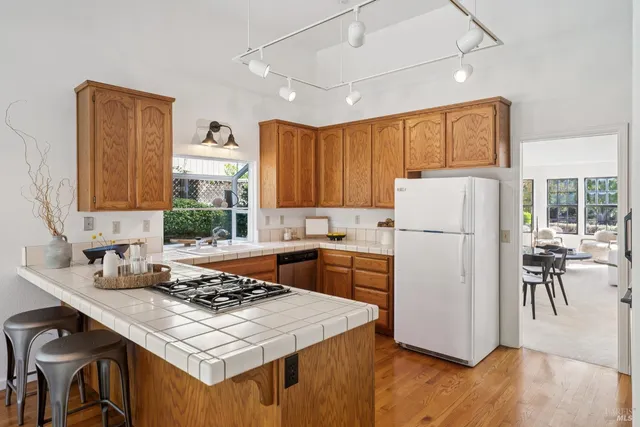 a living room with furniture a fireplace and a potted plant