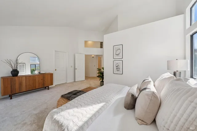 a bathroom with a granite countertop tub a double vanity sink and a large mirror