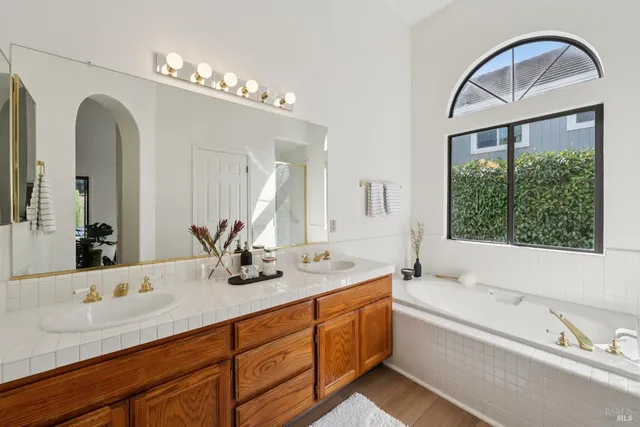 a bathroom with a double vanity sink toilet and a mirror