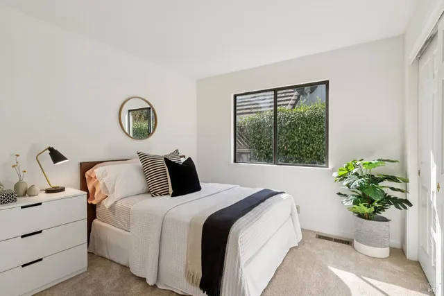a view of a patio with a table and chairs under an umbrella