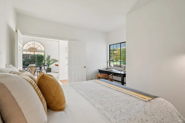 a view of a street with a building and trees in the background